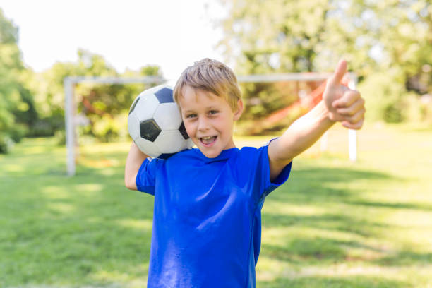 istock Young boy with soccer ball on a sport uniform 841880154