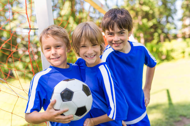 istock three, Young boy with soccer ball on a sport uniform 841883164