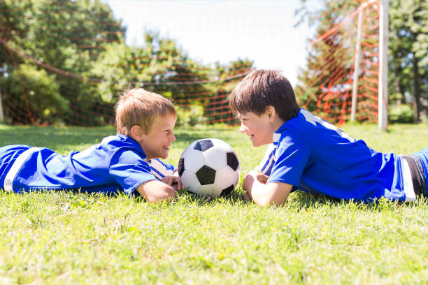 istock Two Young boy with soccer ball on a sport uniform 841883716