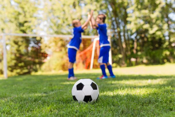 istock Two Young boy with soccer ball on a sport uniform 841884234