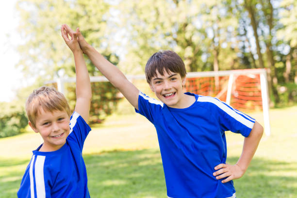 istock Two Young boy with soccer ball on a sport uniform 841884316