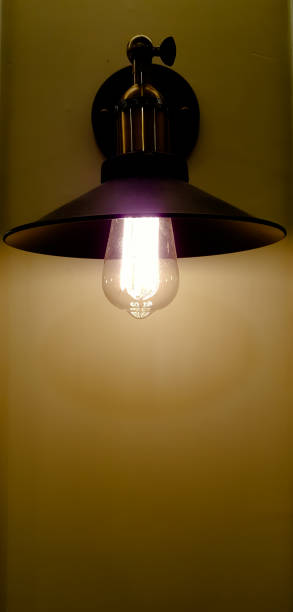 istock Light bulb hanging on wire, isolated on black background 841884538