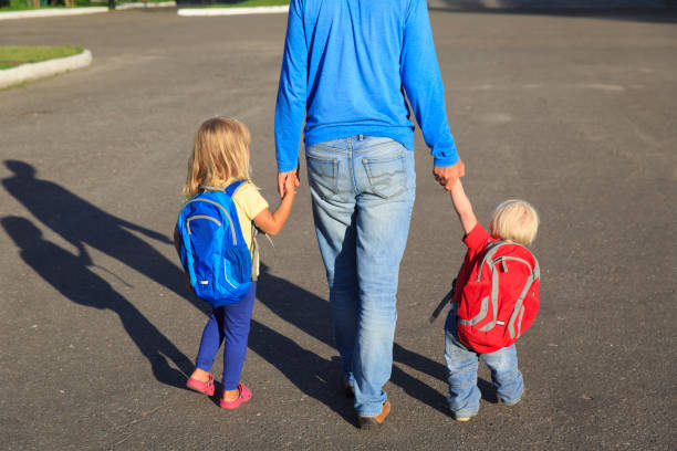 istock father taking kids to school or daycare 841887152