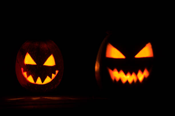 istock two pumpkin heads burn in the night 841887366