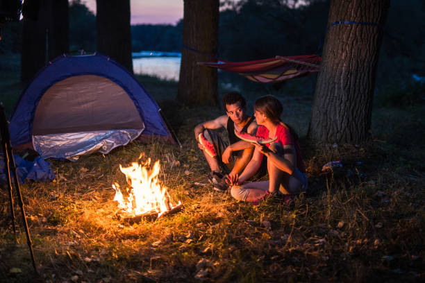 istock Couple camping near the river 841887644