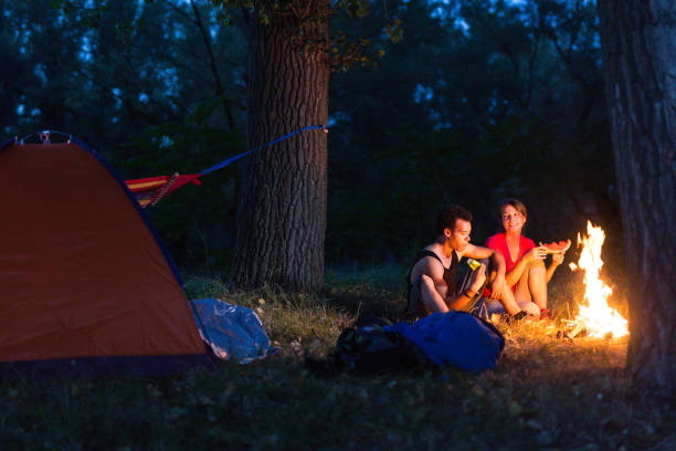 istock Couple enjoying next to the campfire 841887646