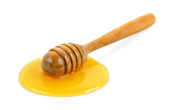 istock Wooden honey dipper with honey 841890870