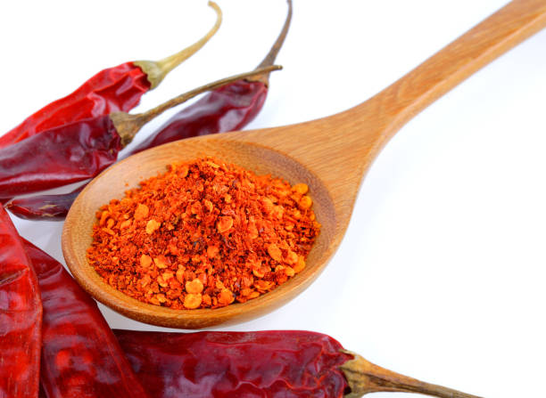istock Cayenne pepper in wood spoon on white background 841890922