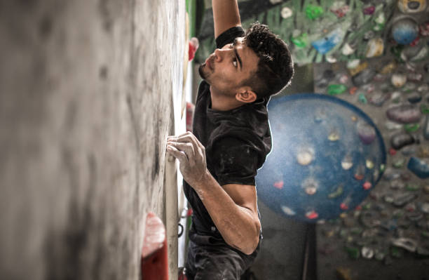 Athlete Climbing in a Bouldering Gym