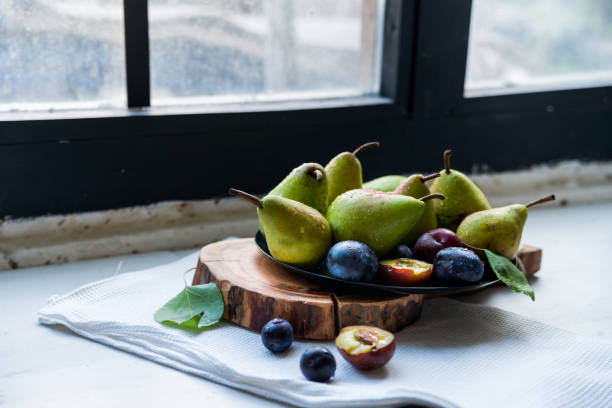istock Studio shot plums and pears on plate heathy diet 841896978