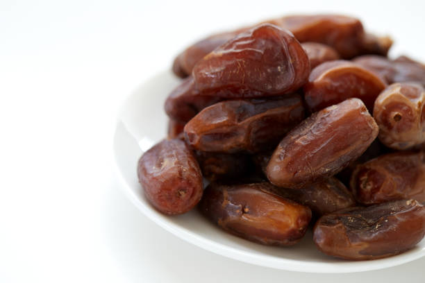 istock Bowl of dried dates isolated on white Background 841897342