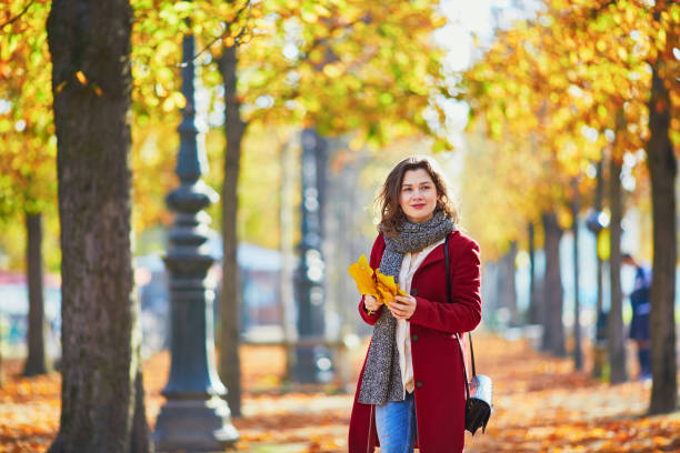istock Beautiful young girl in autumn park 841898836