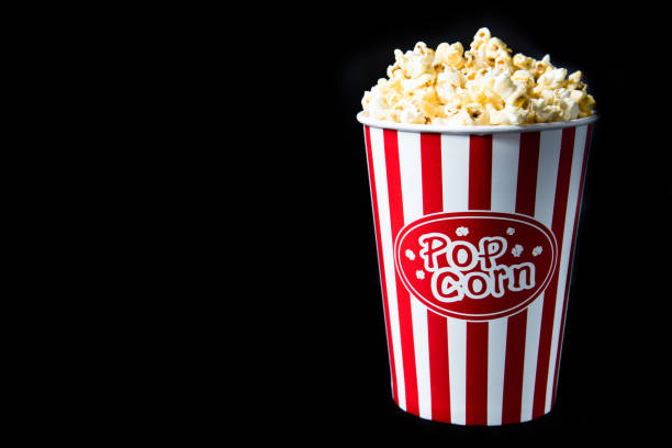 pop corn in bucket pop corn in bucket on black background popcorn snack bowl isolated stock pictures, royalty-free photos & images