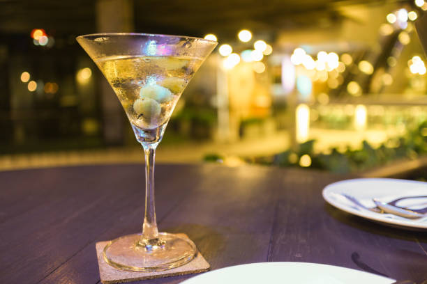 Martini cocktail on transparent glass with bokeh background