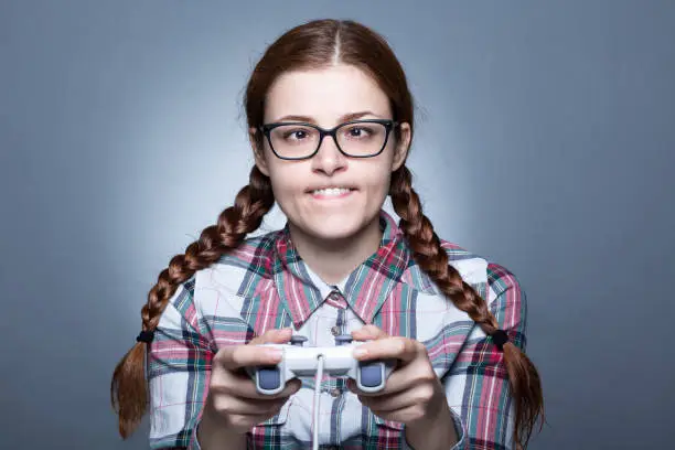 Nerd Woman with Braid Playing Videogames with a Joypad