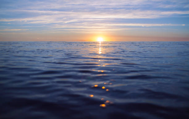 istock Sunset on a body of water 841905386