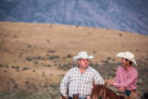 istock utah cowboyS with stetson horseback riding at dusk 841905652