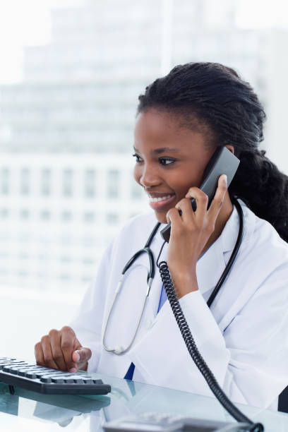 istock Portrait of a female doctor on the phone while using a computer 841912464