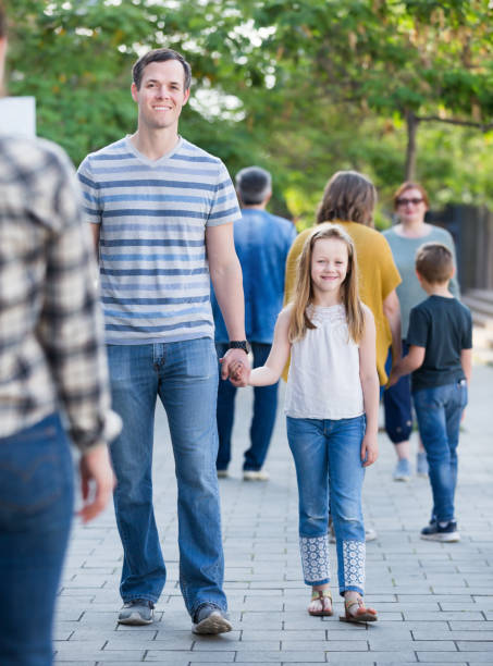 istock People of different ages walk in park 841913798