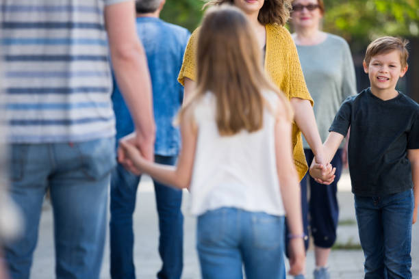 istock People of different ages walk in park 841913826