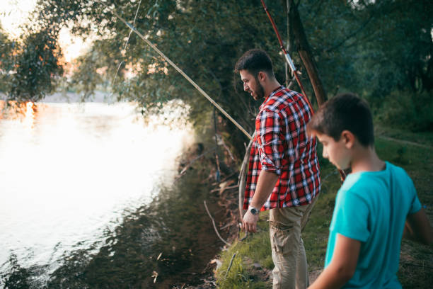 istock Father and son fishing together 841916510