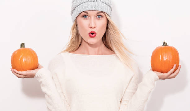 istock Young woman holding pumpkins 841923682