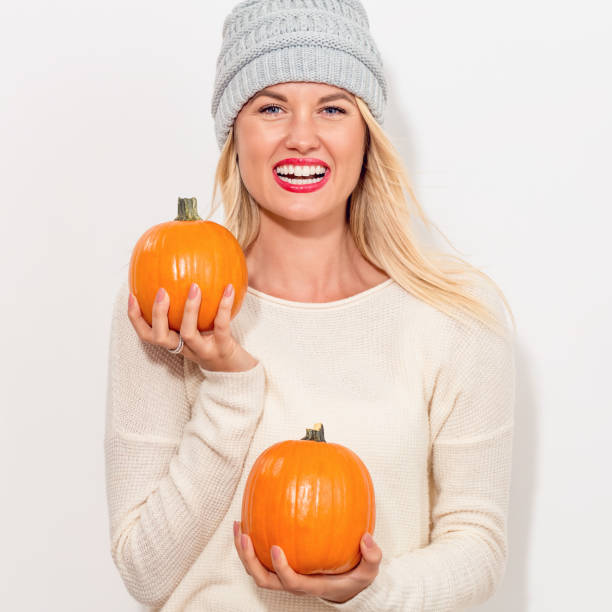 istock Young woman holding pumpkins 841923688