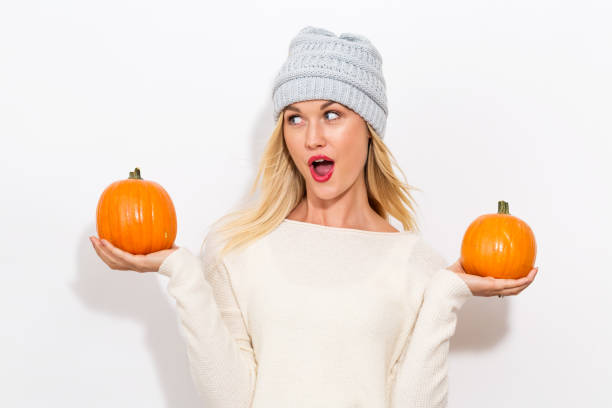 istock Young woman holding pumpkins 841923706