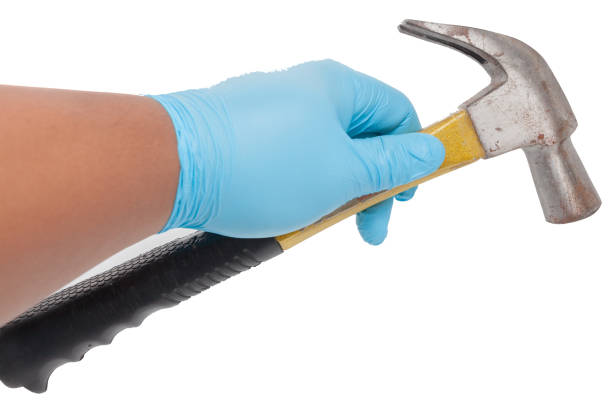 istock hand in blue glove holding a hammer 841924146