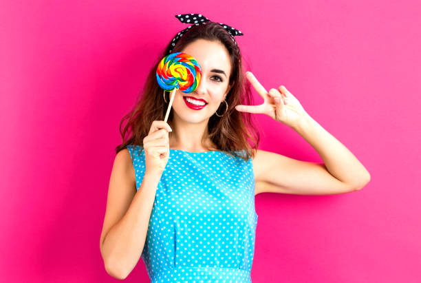 istock Young woman holding a lollipop 841924390