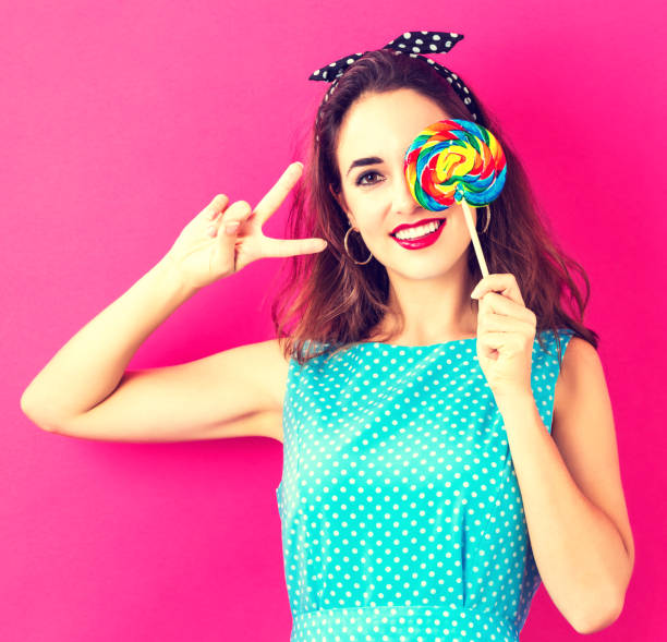 istock Young woman holding a lollipop 841924472