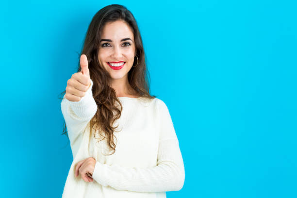 istock Happy young woman giving a thumb up 841924498