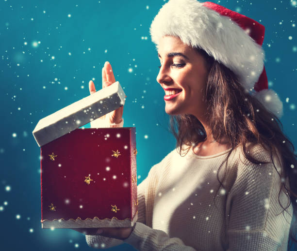 Happy young woman with Christmas present box