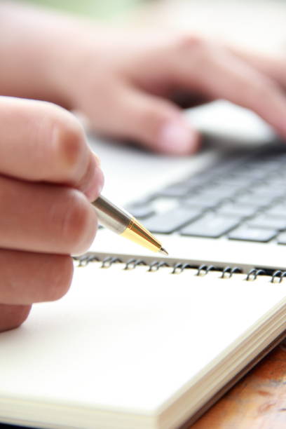 istock Female hand writing with laptop 841930748