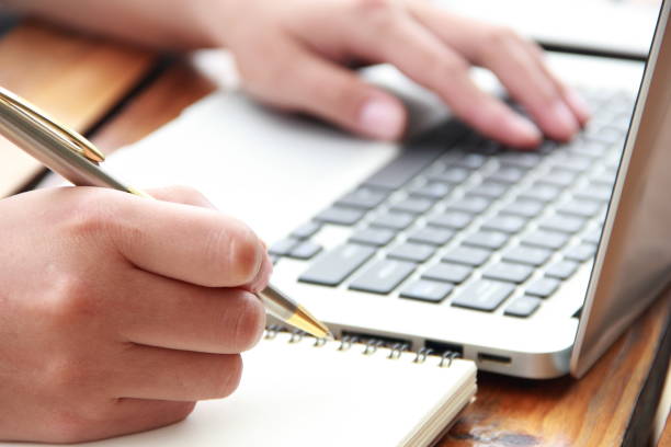 istock Female hand writing with laptop 841930798