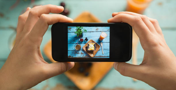 istock Hands taking photo of breakfast with mobile phone 841930852