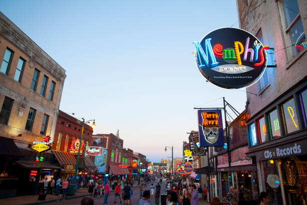 View of Beale Street, Memphis, TN Memphis, TN, USA - June 25, 2017: View of a crowd of tourists enjoying the music clubs and retail establishments that line the famous music district of Beale Street in downtown Memphis, TN at dusk.  Beale Street is on the U.S. National Register of Historic Places. memphis tennessee stock pictures, royalty-free photos & images