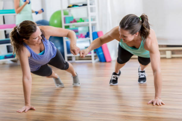 istock Friends fist bump while in plank position 841934540