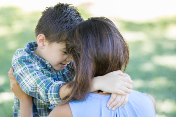istock Sweet young boy gives his mom a hug 841934652
