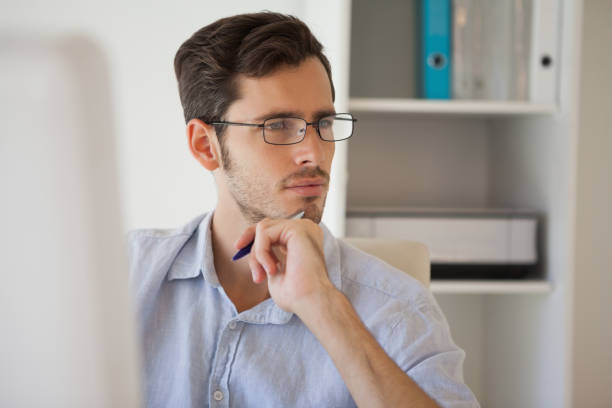 istock Casual businessman thinking at his desk 841934962