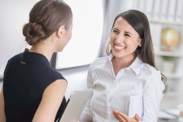 istock Attractive female CEO discusses something with her assistant 841935112