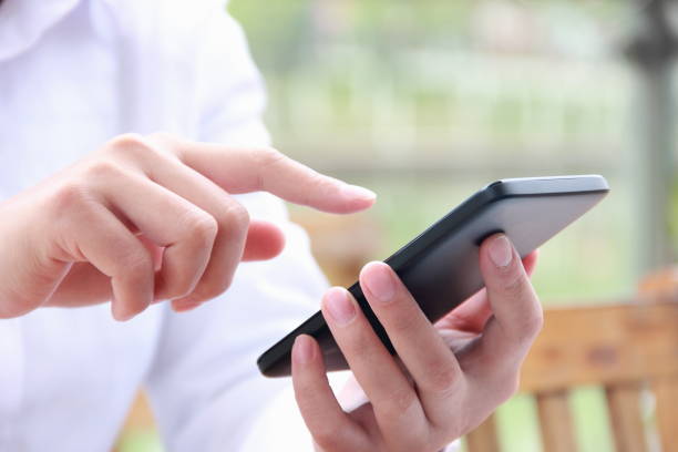 istock Woman using mobile phone outdoors 841935230