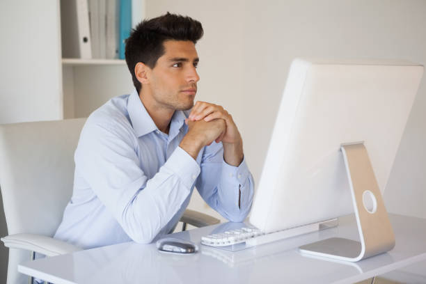 istock Casual businessman concentrating at his desk 841935546
