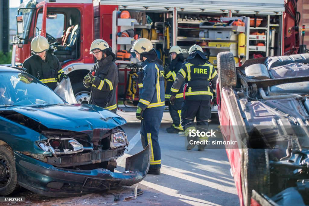 Firefighters at accident"n Firefighters at car accident."n Car Accident Stock Photo