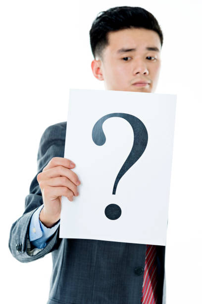 istock Confused businessman holding question mark 841941112