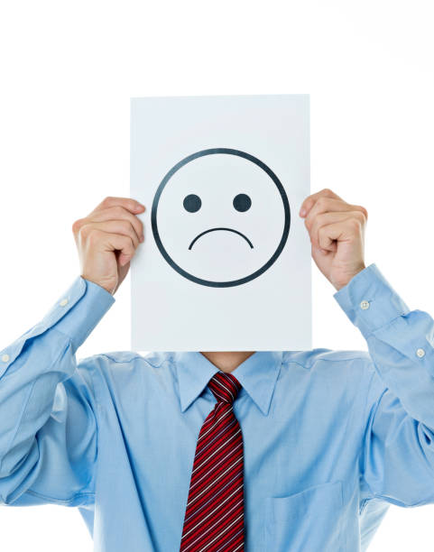 istock Businessman holding paper with sad face 841941340