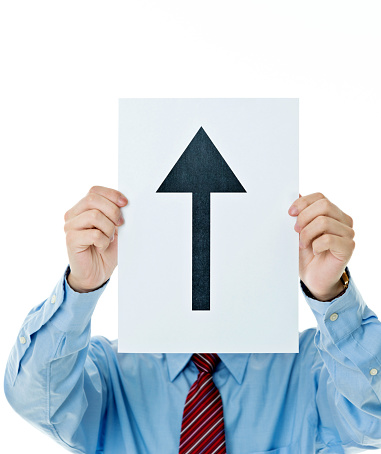 Businessman holding a paper with arrow up sign