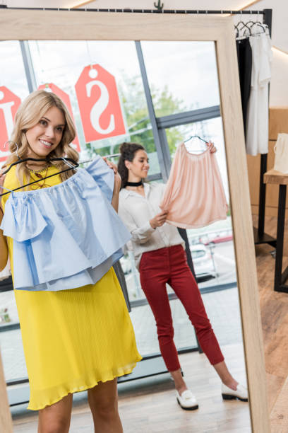 istock young beautiful women in clothes store 841941562