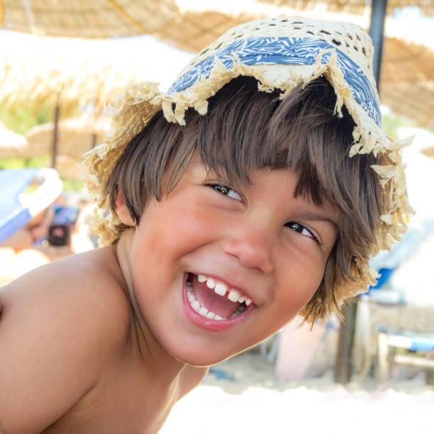 istock Portrait of a boy with hat on the sandy beach 841941586