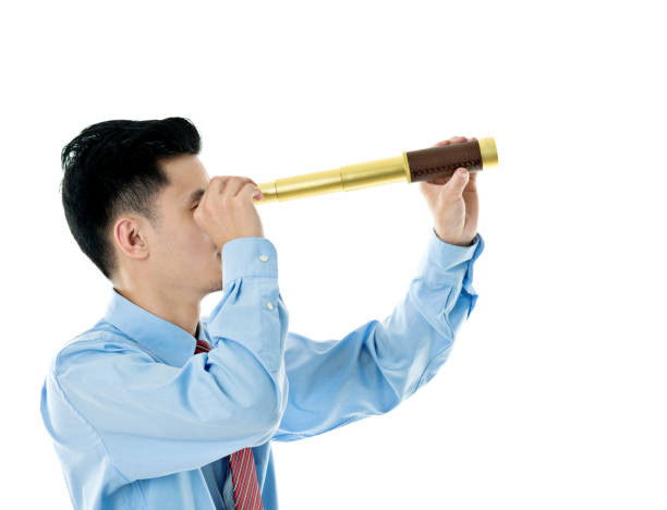 istock Young businessman looking through telescope 841941624